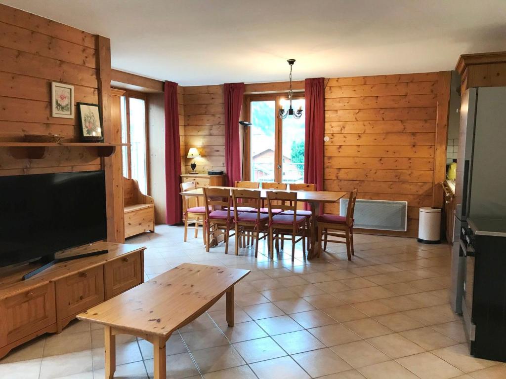 sala de estar con mesa, sillas y TV en Appartement Chamonix-Mont-Blanc, 3 pièces, 4 personnes - FR-1-507-34, en Chamonix-Mont-Blanc