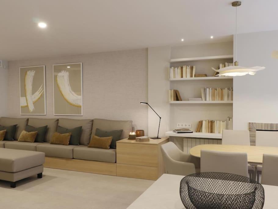 a living room with a couch and a table at Sitges Spaces Bonaire Beach, Near Everything in Sitges