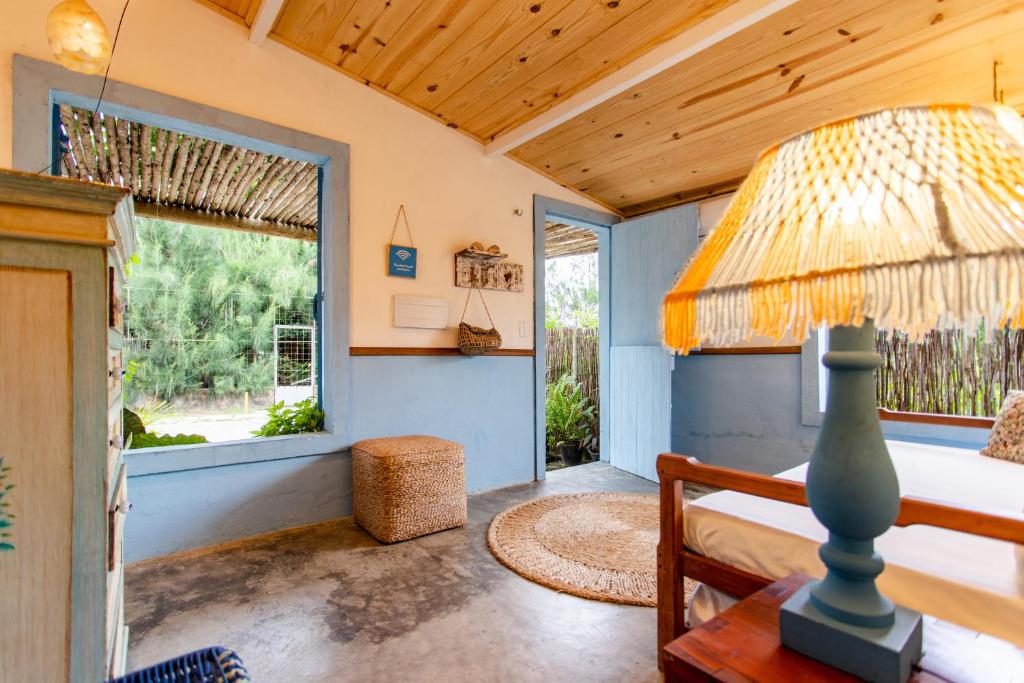 a bedroom with a bed and a lamp on a table at Casa PROX AO MAR - Icaraizinho de Amontada in Amontada