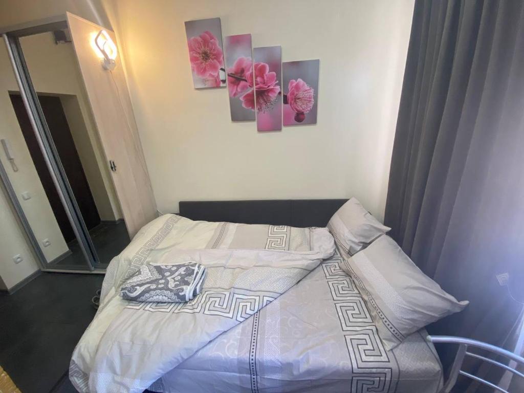 1 cama en un dormitorio con 2 pinturas en la pared en Luxury Room_Karavaeva en Dnipró