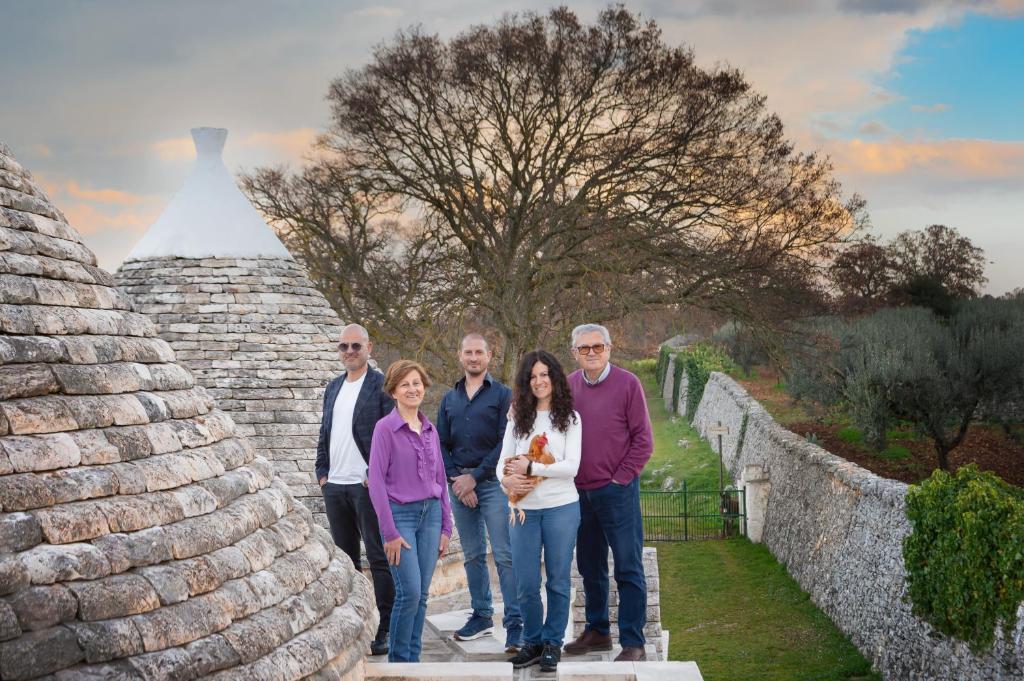 a group of people standing on the steps of a pyramid at Agriturismo Masseria Aprile in Locorotondo