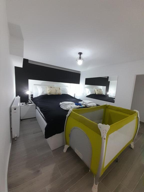 a bedroom with a large bed and a yellow tub at K&K Luxury Loft Apartment in Serres