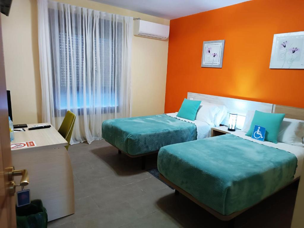 Postel nebo postele na pokoji v ubytování Hotel Alma Rosa
