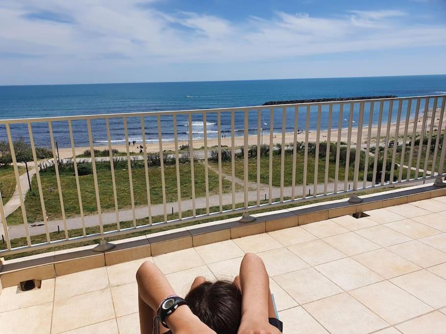 une personne sur un balcon donnant sur l'océan dans l'établissement Magnifique vue mer La terrasse de Poséidon, au Cap d'Agde
