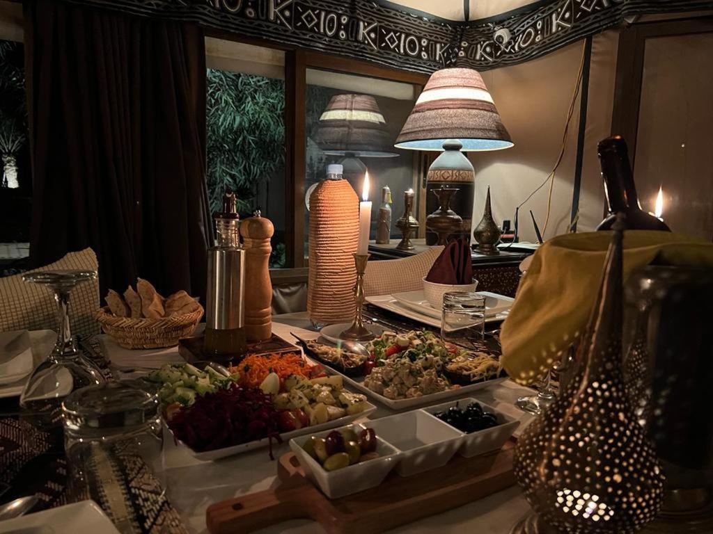 a table topped with plates of food on a table at Merzouga Luxury Tented Camp in Merzouga