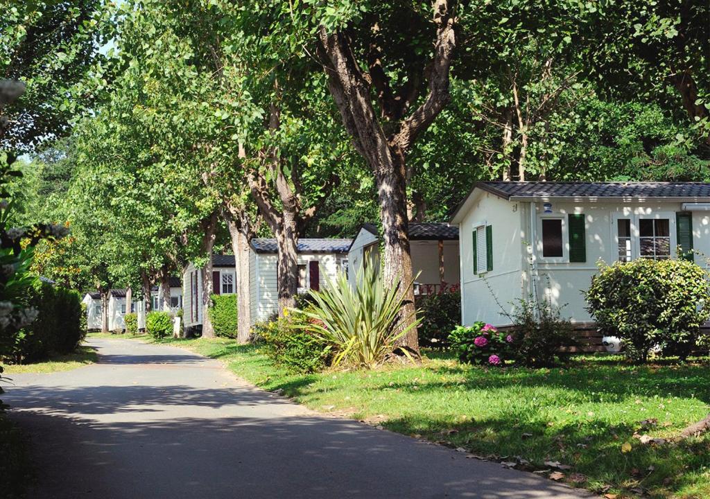 a house and a road with a house and trees at Camping ZELAIA in Ascain