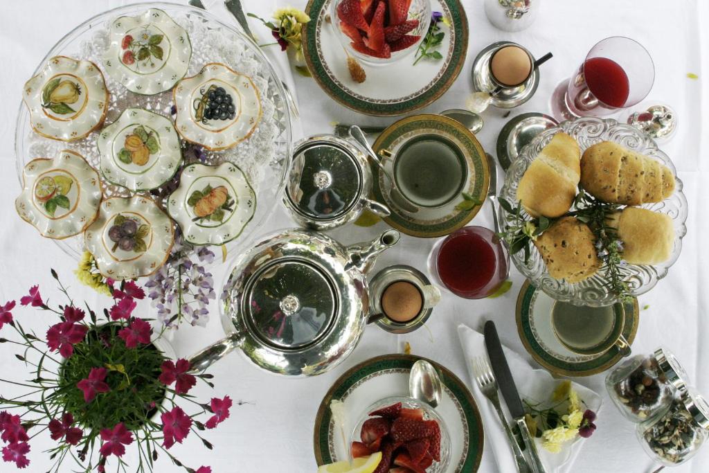 a white table with plates of food on it at Casa Nobile in Tovo San Giacomo