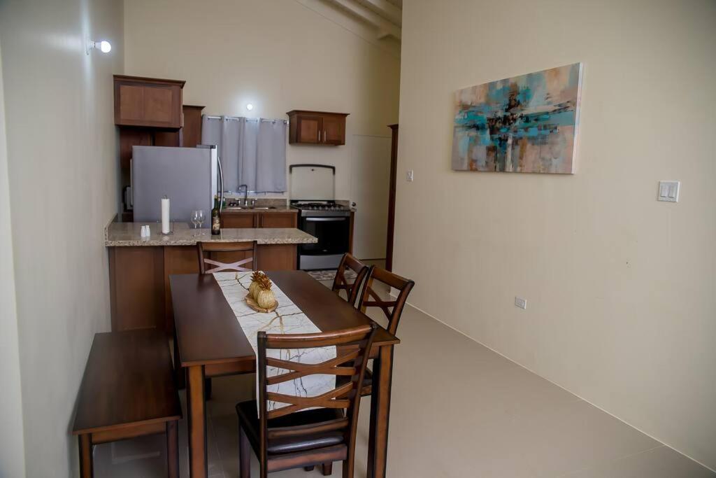 a kitchen with a table and chairs in a room at Entire residential home • Trelawny• Smalls Villa in Florence Hall
