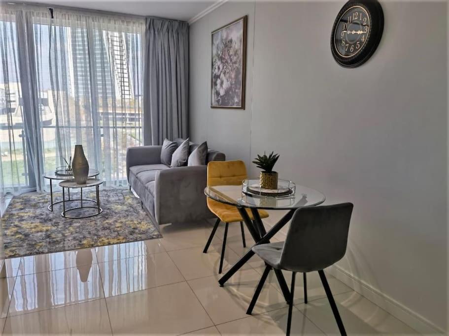 a living room with a couch and a table at Executive Suite at Ellipse in Waterfall Midrand in Midrand