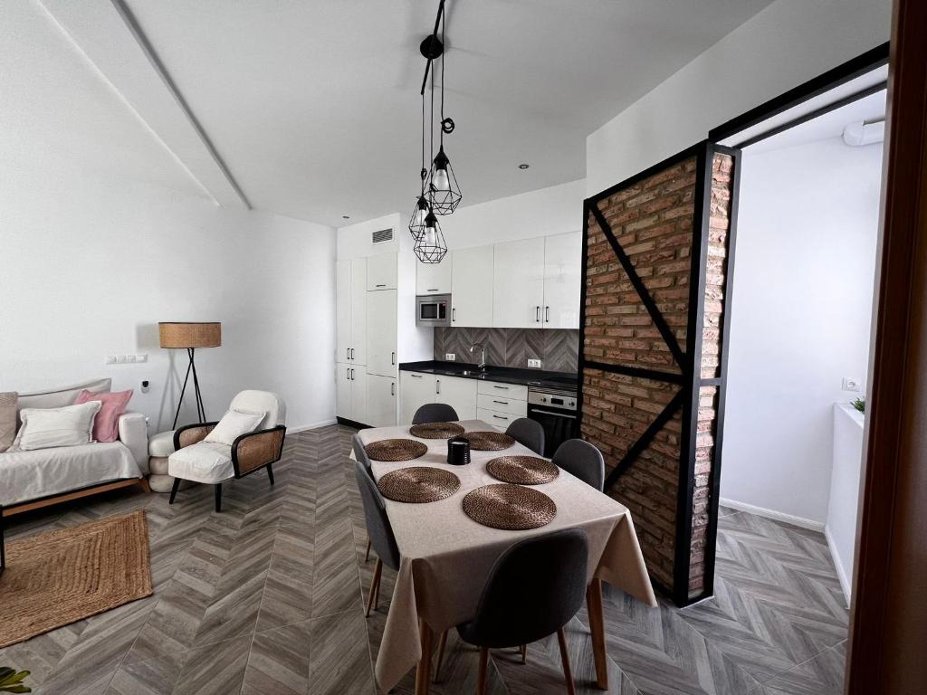 a living room with a table and a couch at Luxury new 6 pax apart Downtown. in Córdoba