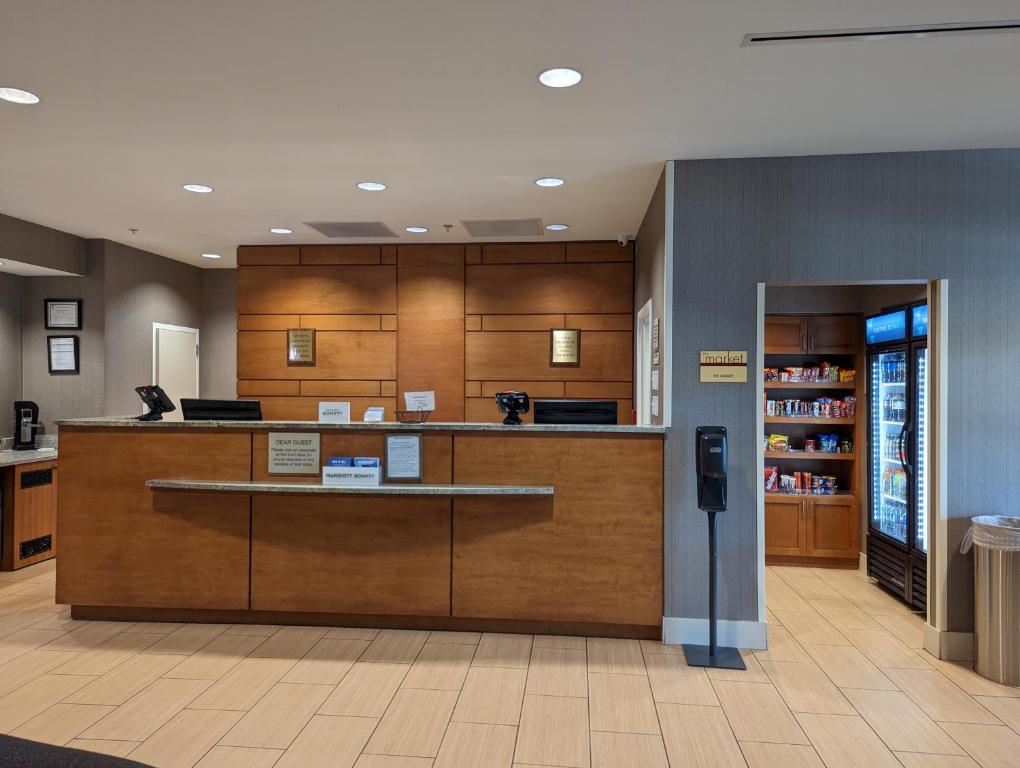 a lobby of a hospital with a counter and a pharmacy at SpringHill Suites by Marriott Athens West in Athens