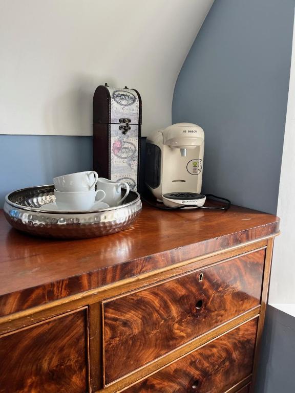 a wooden dresser with a coffee maker on top of it at Stone Lodge B&B in Balrath