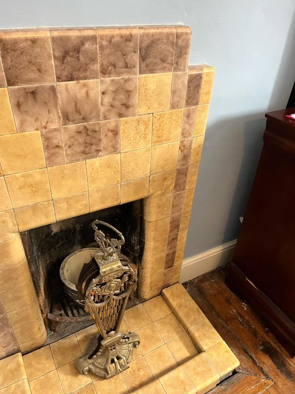 a brick fireplace with a metal object in it at Stone Lodge B&B in Balrath