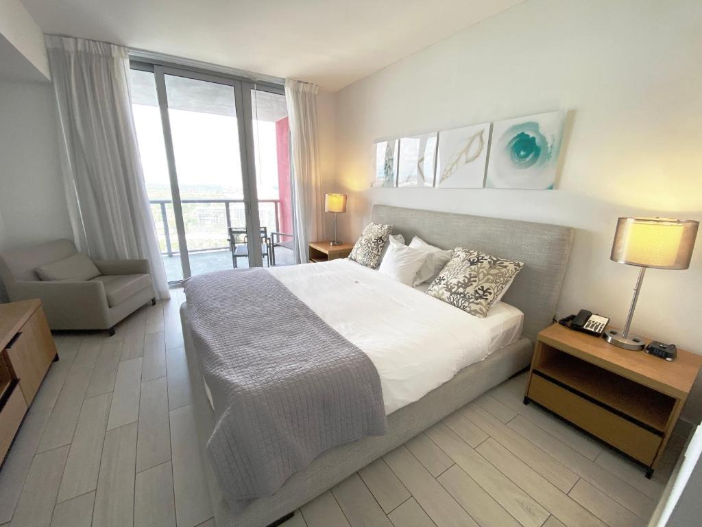 a bedroom with a large bed and a large window at Amazing 1B-1B Apartment With Amazing View! 28A in Hallandale Beach