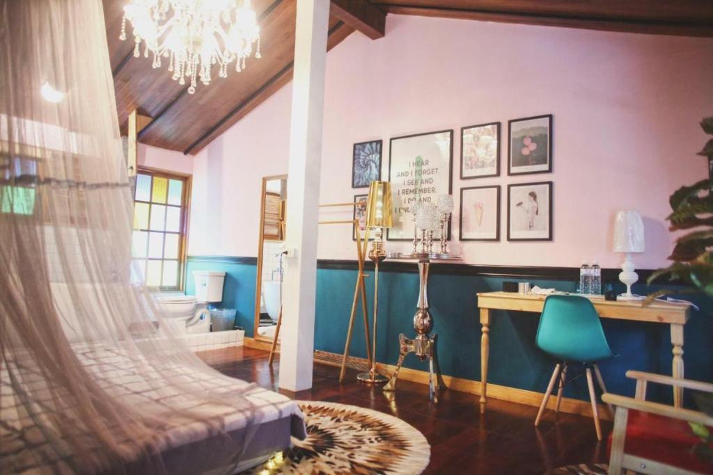 a living room with a chandelier and a desk in a room at T-House BKK 2Floors near BTS with swimming pool and free Wifi in Klong Toi