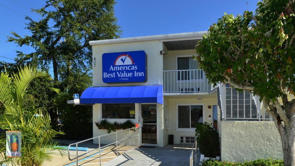 a best value inn building with a blue awning at Americas Best Value Inn Bradenton-Sarasota in Bradenton