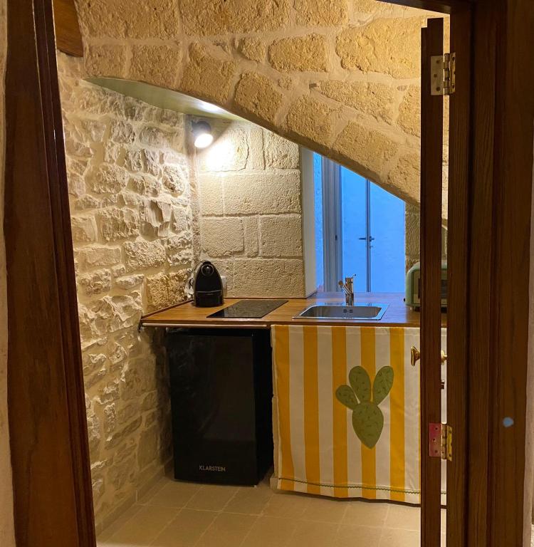 a kitchen with a sink and a counter top at Casa Vacanze Disque Rouge in Trani