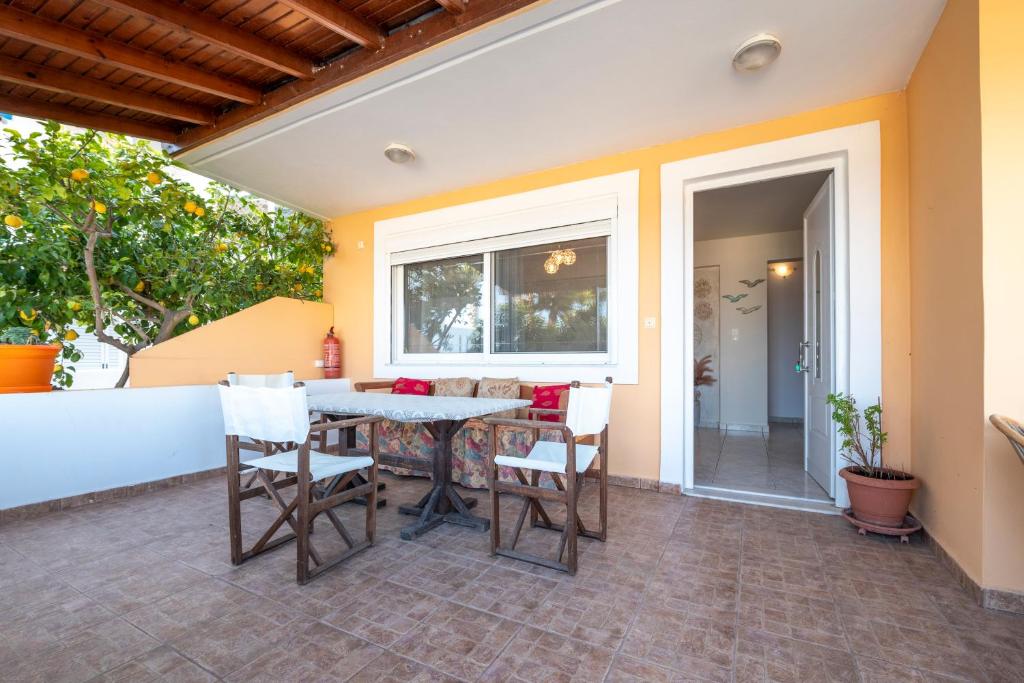 a patio with a table and chairs on a patio at Villa Giorgos in Kefalos