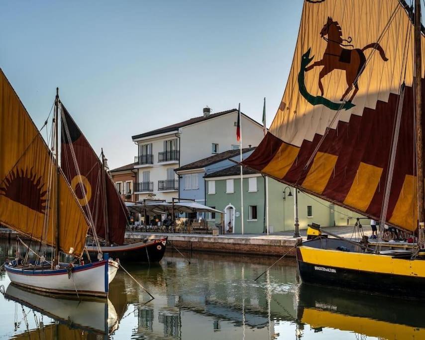 two sailboats are docked in the water in a harbor at CasaDodici Boutique Hotel in Cesenatico