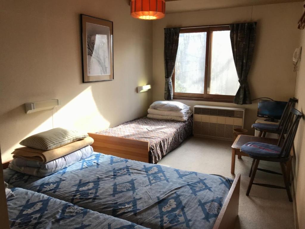 Ein Bett oder Betten in einem Zimmer der Unterkunft New Togakushi Sea Hail - Vacation STAY 61073v