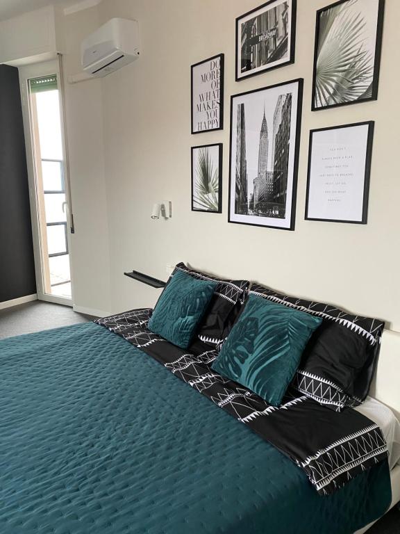 uma cama com almofadas pretas e verdes num quarto em Skyline em Novara