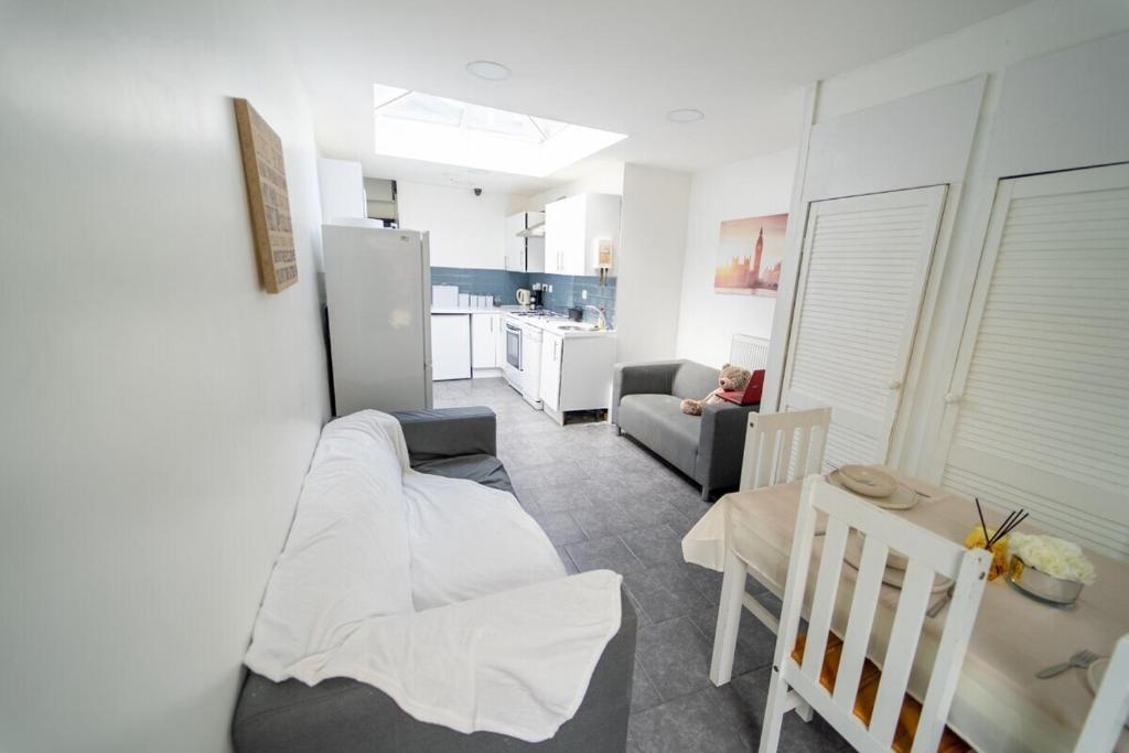 a living room with a couch and a table and a kitchen at STAY SA Cosy equipped studios available 10 mins from the city! Free WIFI &50" SMART TV's! in Birmingham