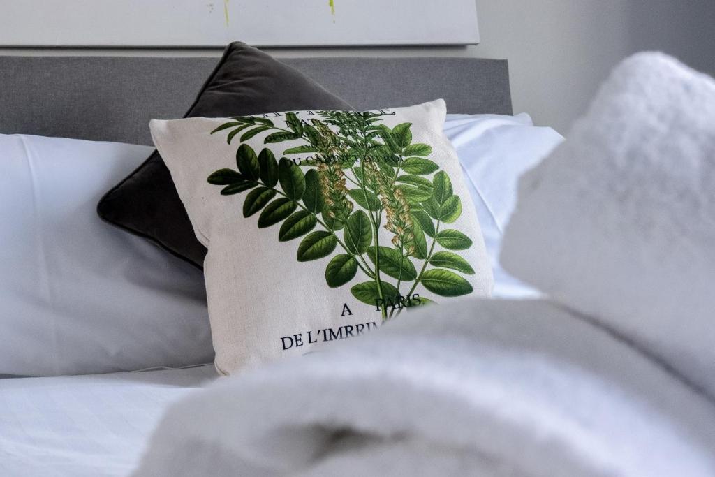 a pillow with a plant on it on a bed at Wester-Moor comfy modern house in Barnstaple by StayStay com in Barnstaple