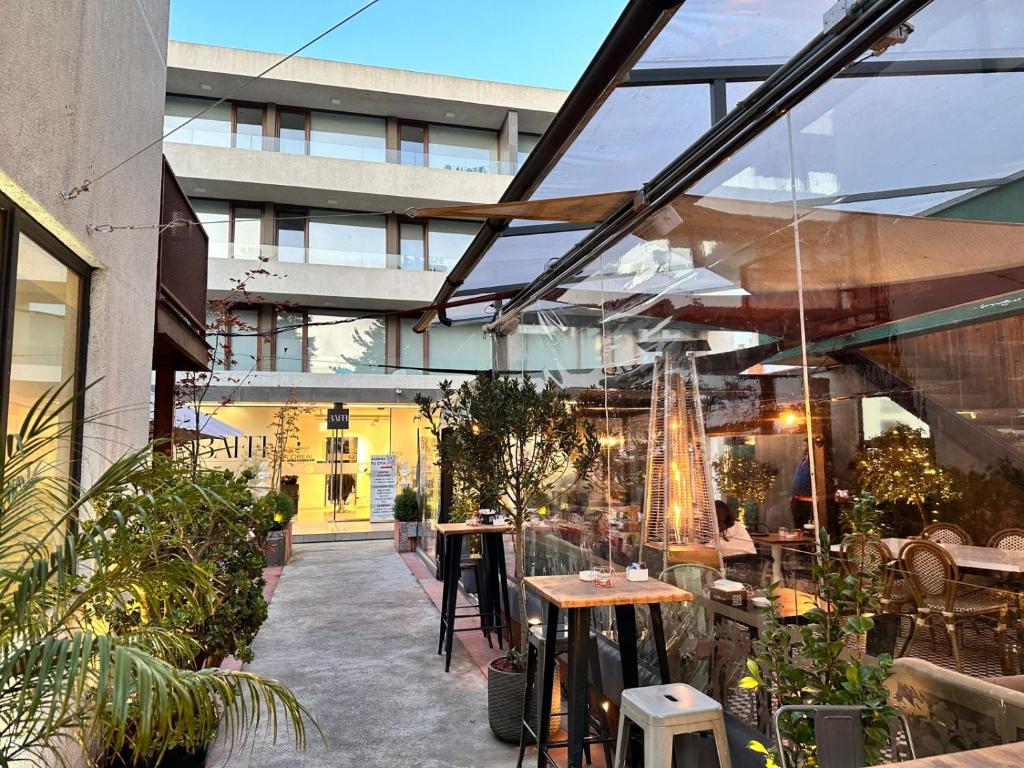 an outdoor patio with tables and umbrellas at Apart Hotel Castellon 176 in Concepción