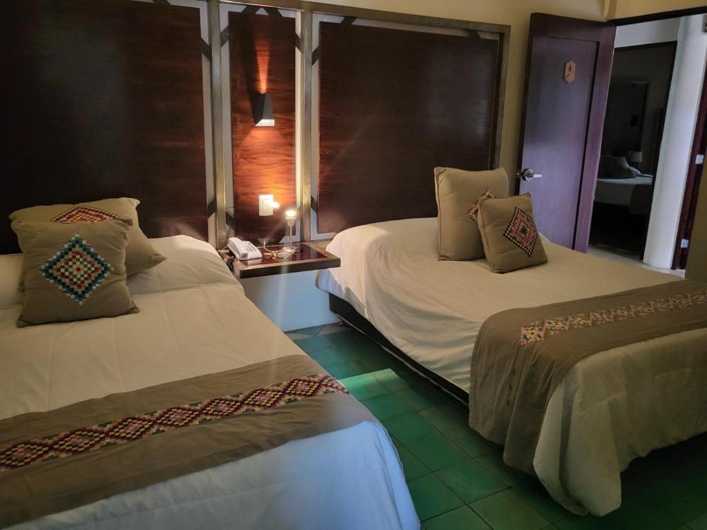 a room with two beds and a window at Hotel Azul Esmeralda in Teapa