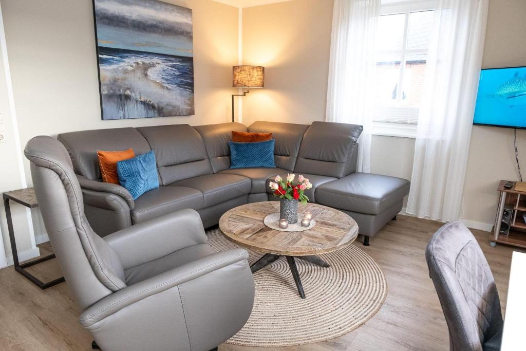 a living room with a couch and a table at Haus-Gotland-Wohnung-10 in Westerland