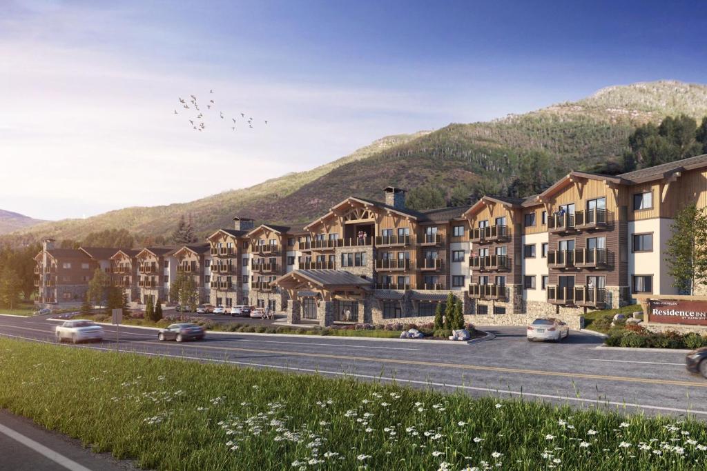 an architectural rendering of a apartment complex with mountains in the background at Residence Inn by Marriott Vail in Vail
