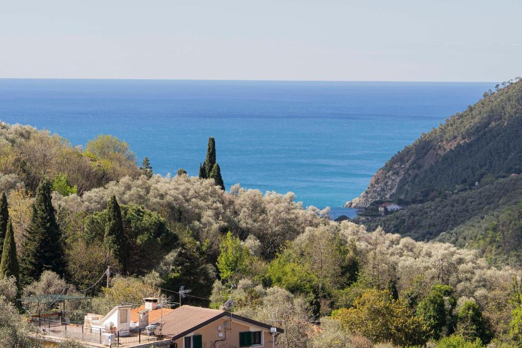 a house on a hill with the ocean in the background at Portico in Moneglia