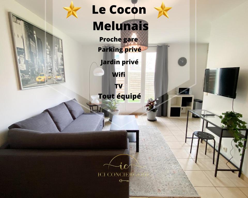 a living room with a couch and a table at Le Cocon Melunais in Melun
