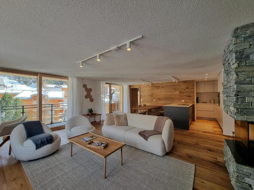 a living room with a couch and a table at Riverside 2nd Floor North in Saas-Fee