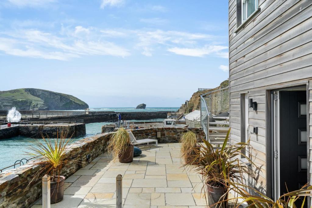 a house with a patio with a view of the ocean at Harbour Master's House in Portreath