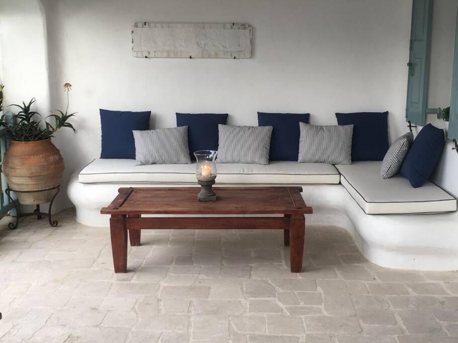a living room with a couch and a table at Mykonos Summer House in Mikonos