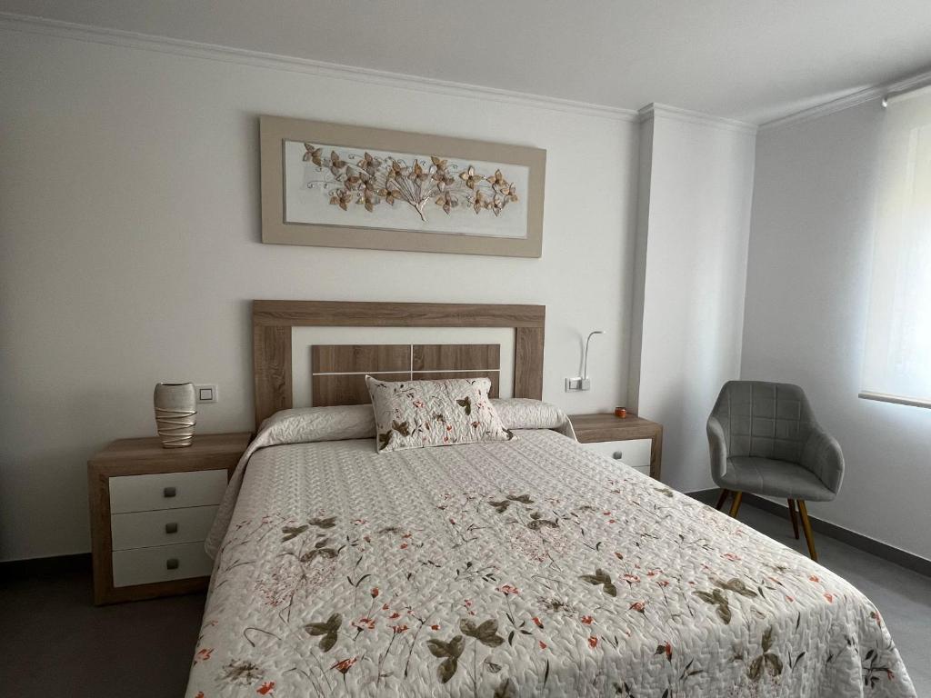A bed or beds in a room at Apartamentos Maria de Lucia- Ático