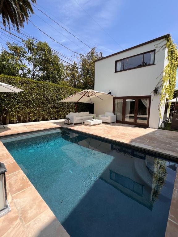 a swimming pool in front of a house at The Cozy Villa in Los Angeles