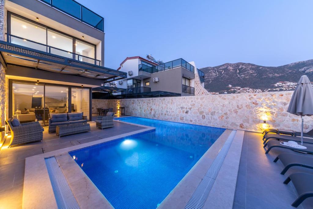 a villa with a swimming pool and a house at Luxurios Private Summerhouse by Renovu in Kalkan