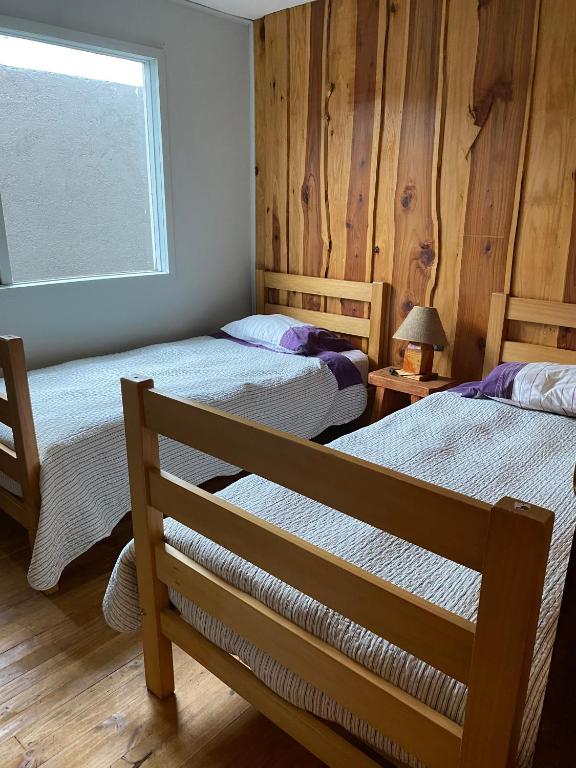 Postel nebo postele na pokoji v ubytování Ruka Pucón Hostel