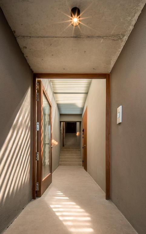 a hallway with a ceiling fan and a hallway with stairs at INSUA BEACH HOUSE in Pontevedra