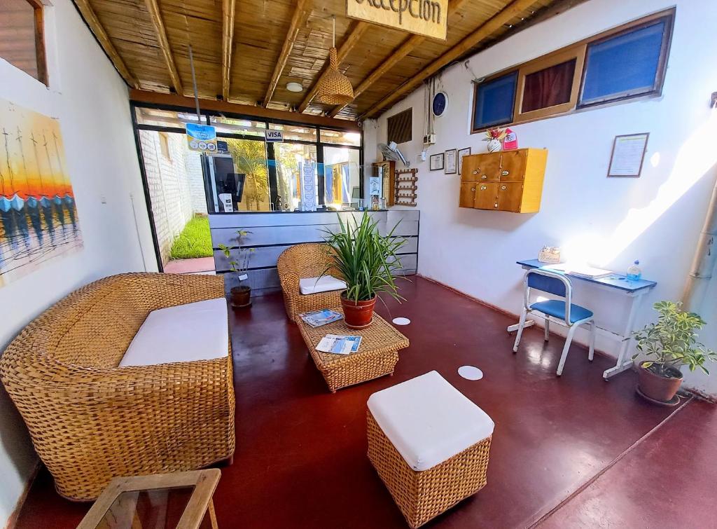 a living room with a couch and chairs and a table at Mancora y Sol in Máncora