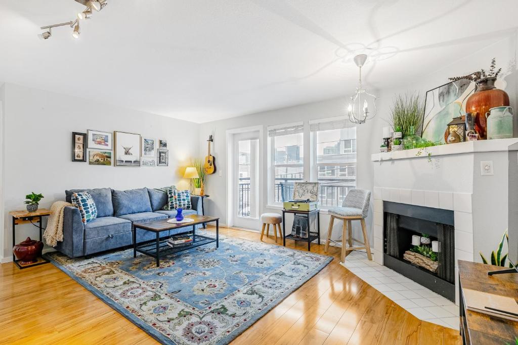 a living room with a blue couch and a fireplace at Humble Sound in Seattle