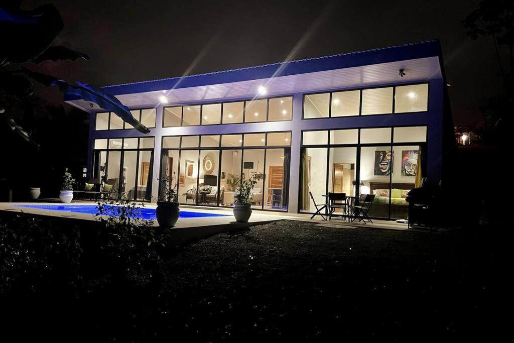 a large building with a lot of windows at night at An abundance of wildlife at Jungle Glory Home in Manuel Antonio