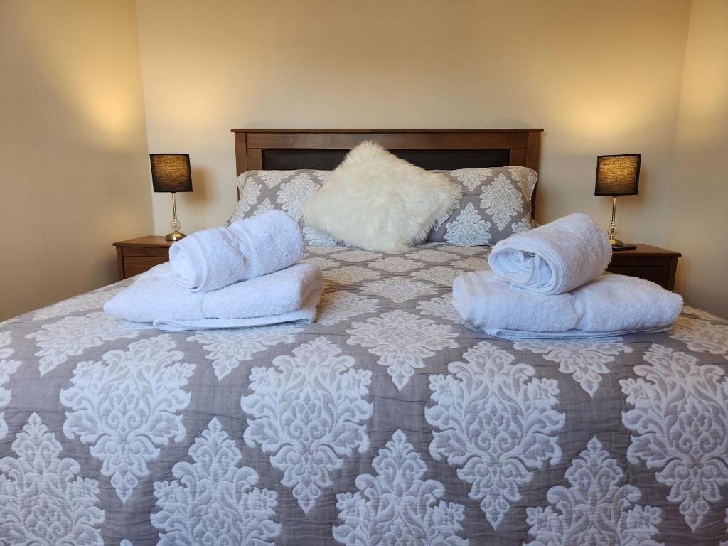 a bedroom with a bed with two pillows on it at Departamento full equipado in Temuco