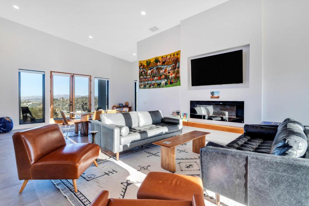 a living room filled with furniture and a flat screen tv at Casa Nicole in Yucca Valley