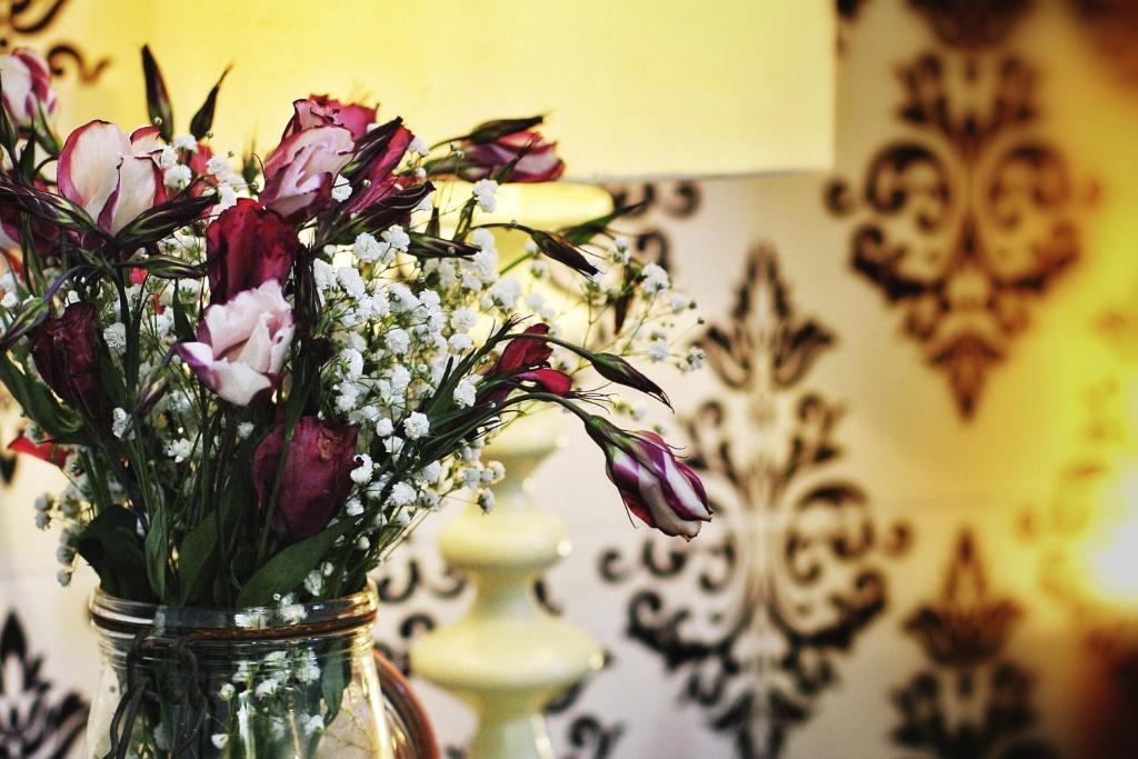 a vase filled with flowers sitting on a table at Beaconsfield Hotel in London