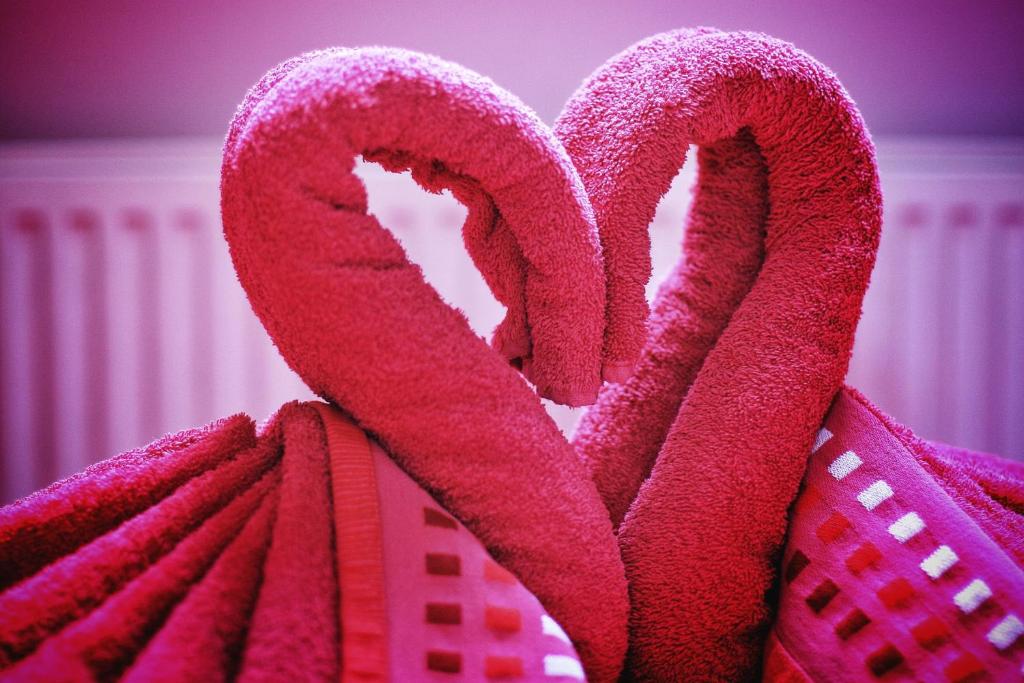 a pile of pink towels in the shape of hearts at Beaconsfield Hotel in London