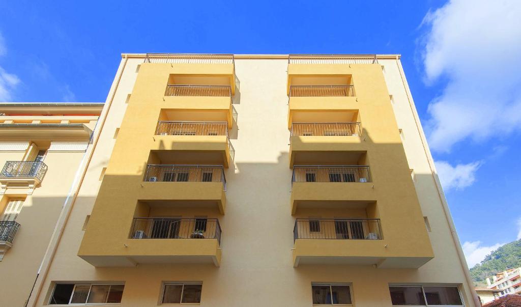a tall building with balconies on the side of it at Villa Serafina Apartements in Nice