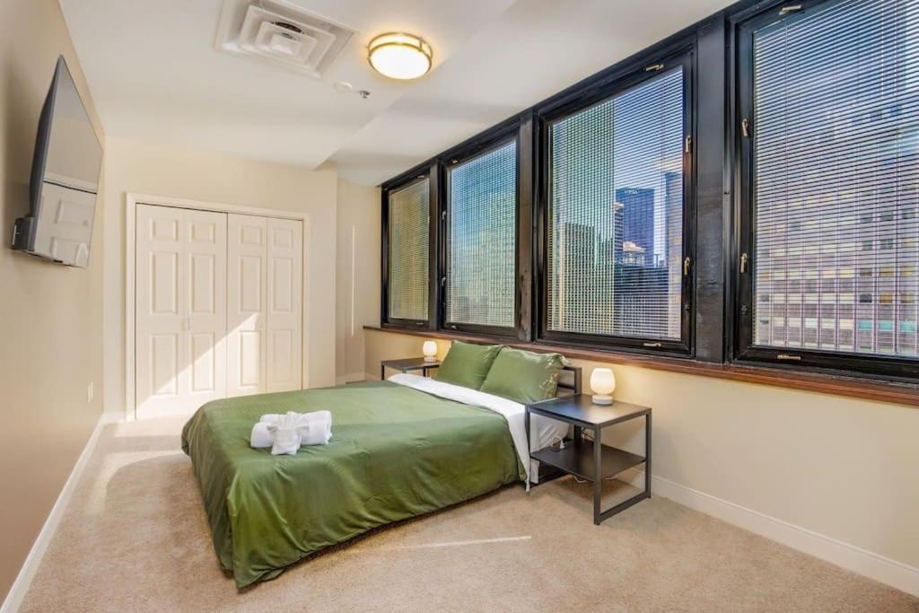a bedroom with a bed with two towels on it at Luxe City Views in DT Pittsburgh VALET GYM WIFI in Pittsburgh